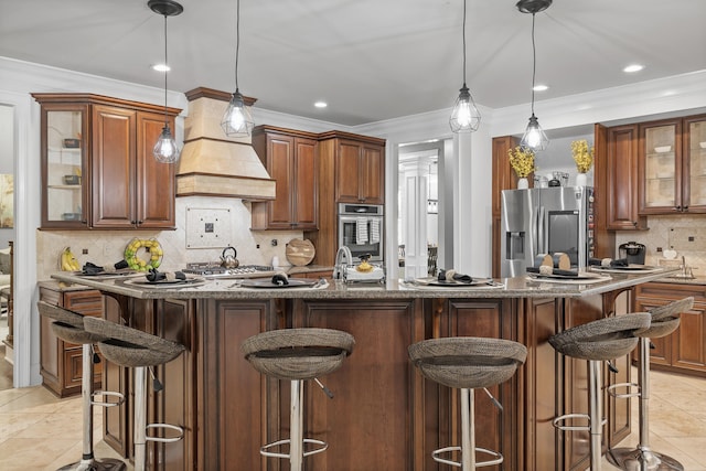 kitchen with tasteful backsplash, a breakfast bar area, hanging light fixtures, stainless steel appliances, and light tile patterned floors