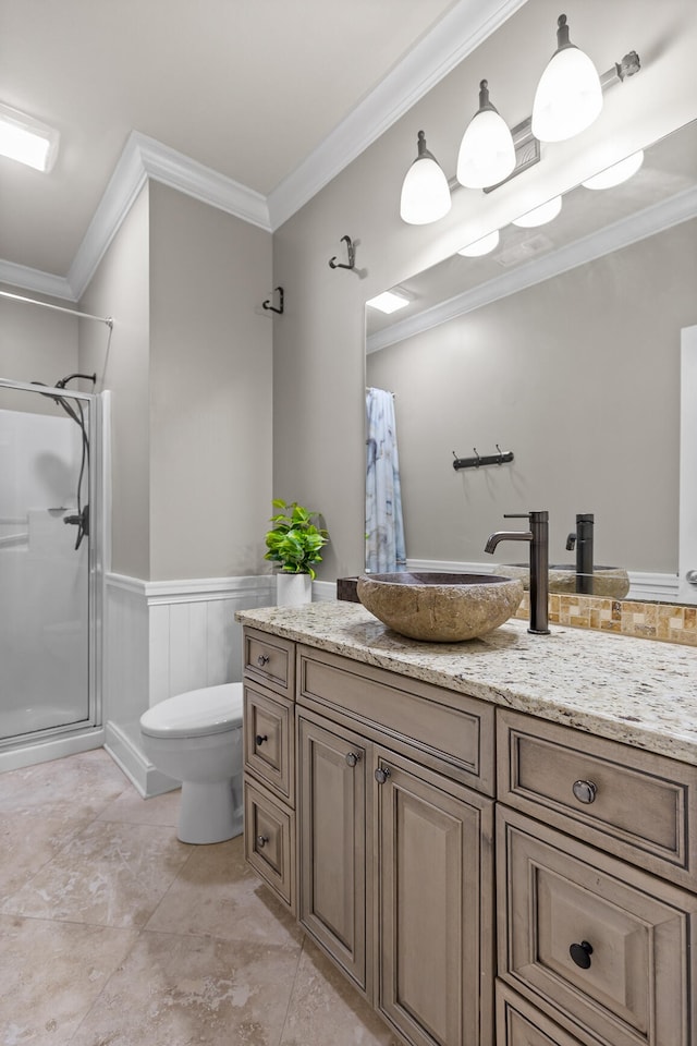 bathroom with vanity, ornamental molding, walk in shower, and toilet