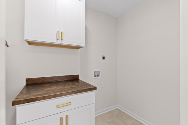 laundry room with hookup for a washing machine, light tile patterned floors, cabinets, and hookup for an electric dryer