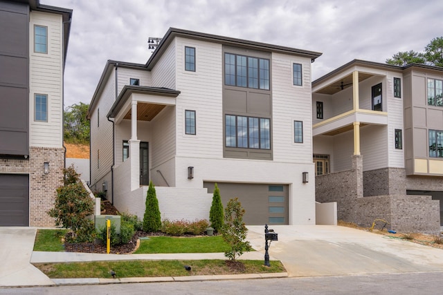 view of front of property featuring a garage and a balcony