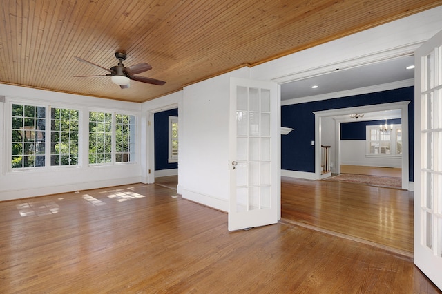 unfurnished room with ornamental molding, french doors, wood ceiling, and wood-type flooring