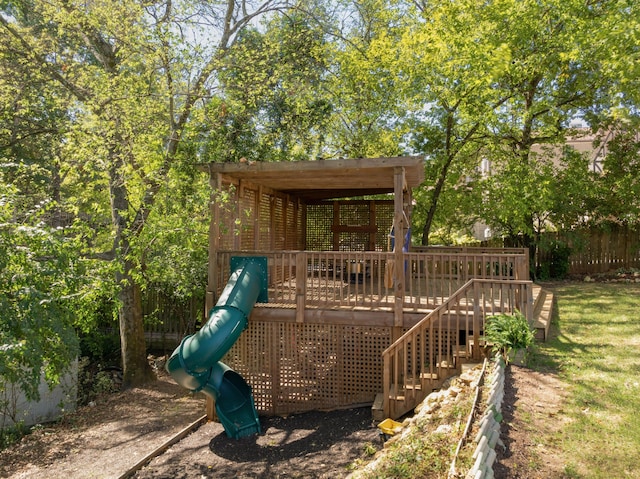 view of play area featuring a wooden deck and a yard