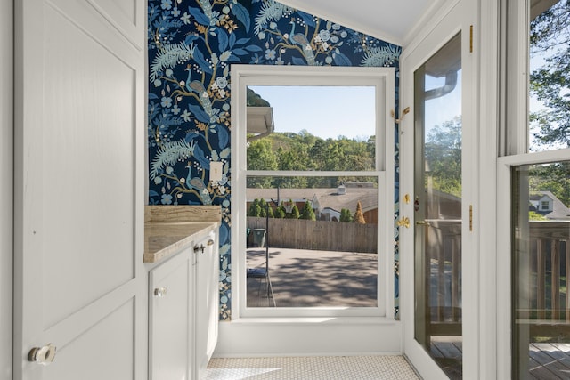 doorway to outside with lofted ceiling