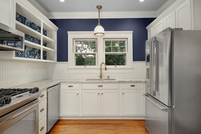 kitchen with stainless steel appliances, light stone countertops, sink, and white cabinets