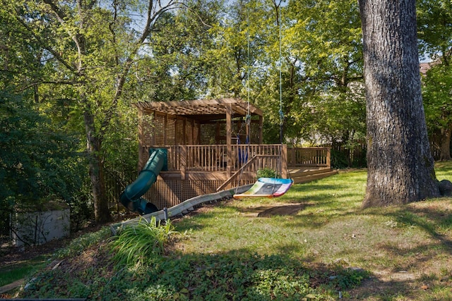 view of jungle gym with a wooden deck and a yard