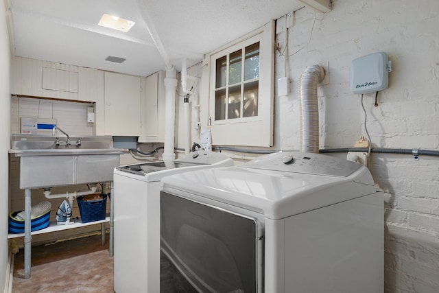 laundry room featuring sink and separate washer and dryer