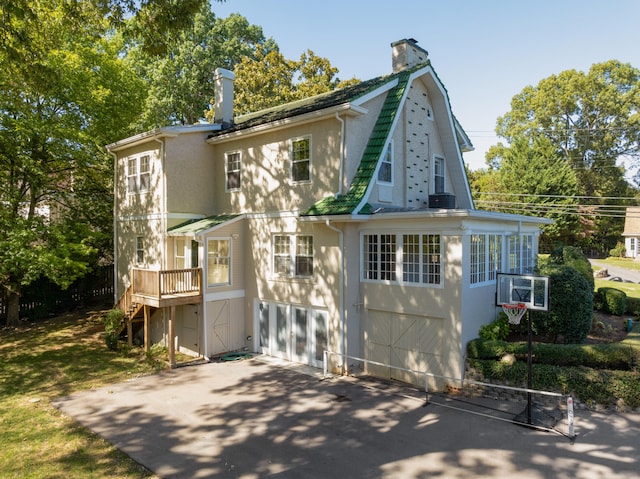 rear view of house featuring a garage