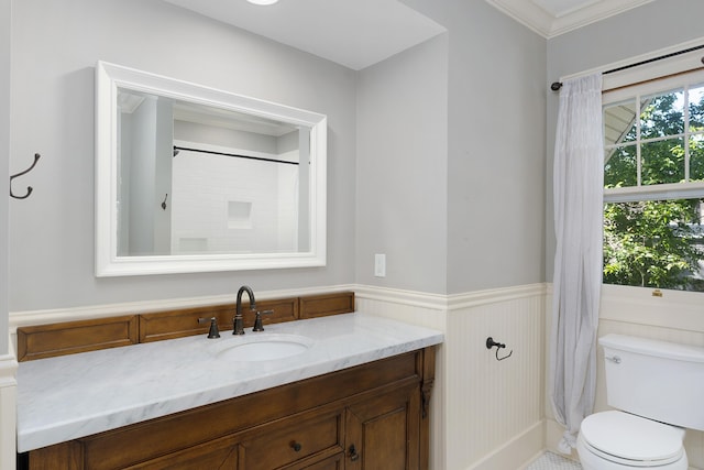 bathroom with toilet, ornamental molding, walk in shower, and vanity