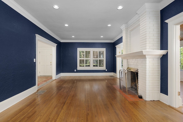 unfurnished living room featuring crown molding, a fireplace, and hardwood / wood-style floors