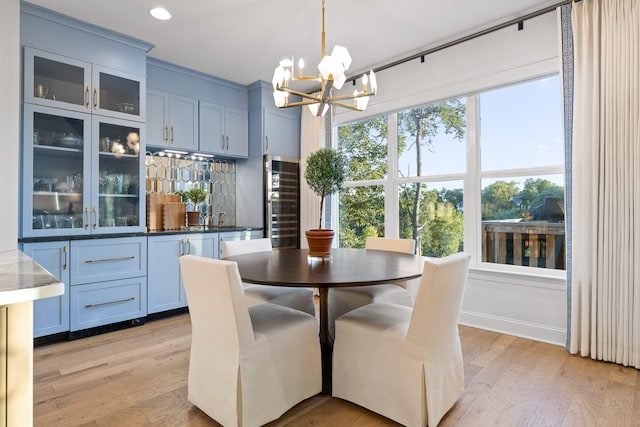 dining area featuring an inviting chandelier and light hardwood / wood-style flooring