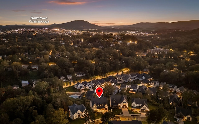 aerial view at dusk featuring a mountain view