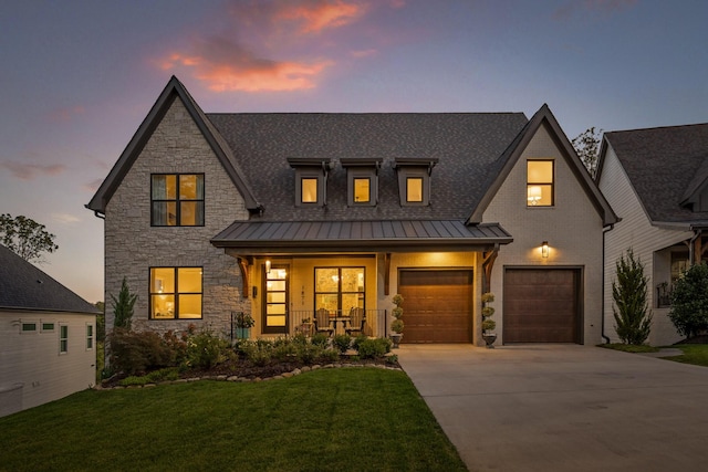 1871 Notting Hl, Chattanooga, TN 37405 - view of front of property featuring a standing seam roof, driveway, stone siding, covered porch, and a lawn