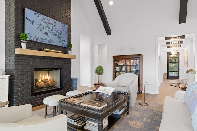 living room with beam ceiling, a fireplace, high vaulted ceiling, and hardwood / wood-style flooring