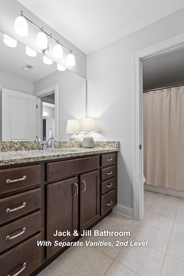 bathroom featuring vanity, toilet, and tile patterned flooring