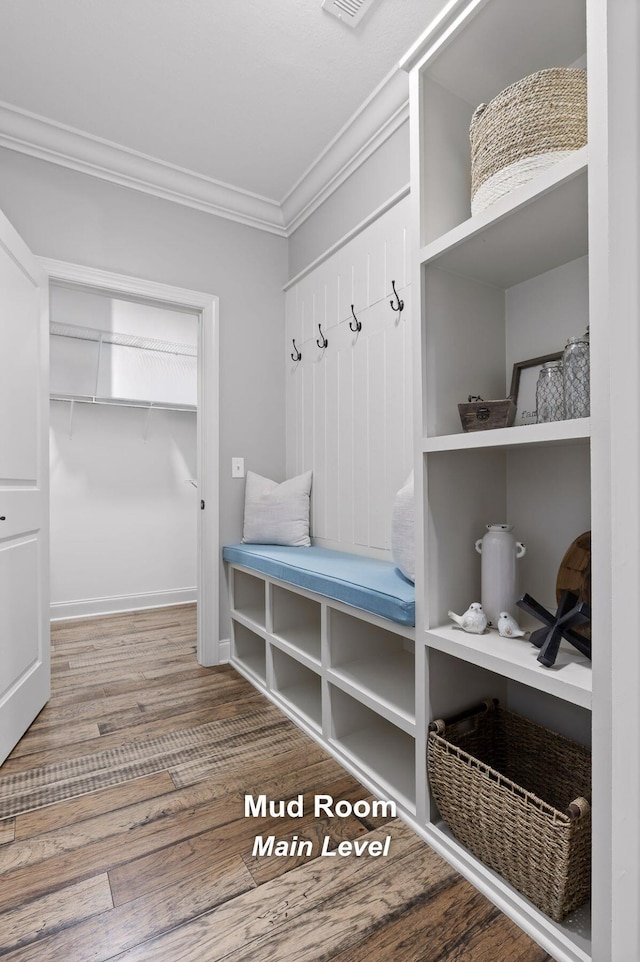 mudroom with ornamental molding and hardwood / wood-style floors