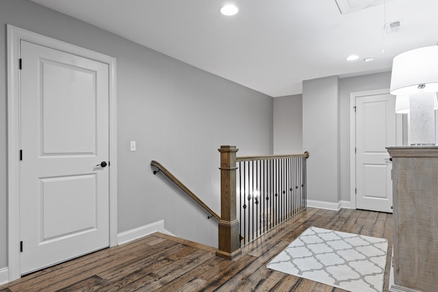 stairs with hardwood / wood-style flooring