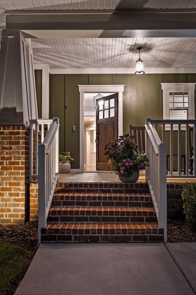 view of exterior entry with covered porch