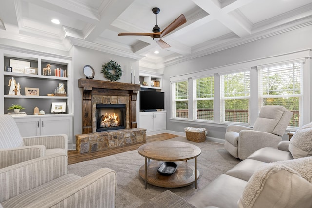 living room with a fireplace, light hardwood / wood-style flooring, ornamental molding, built in shelves, and ceiling fan