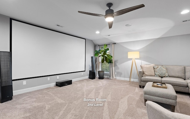 cinema with ceiling fan and light colored carpet