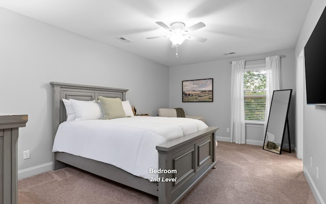 bedroom with ceiling fan and light colored carpet