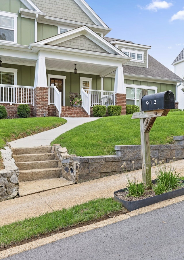 craftsman-style house with a porch and a front lawn