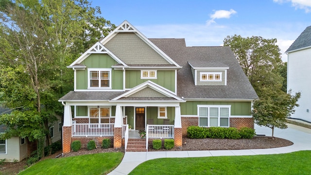 craftsman-style house with covered porch and a front lawn