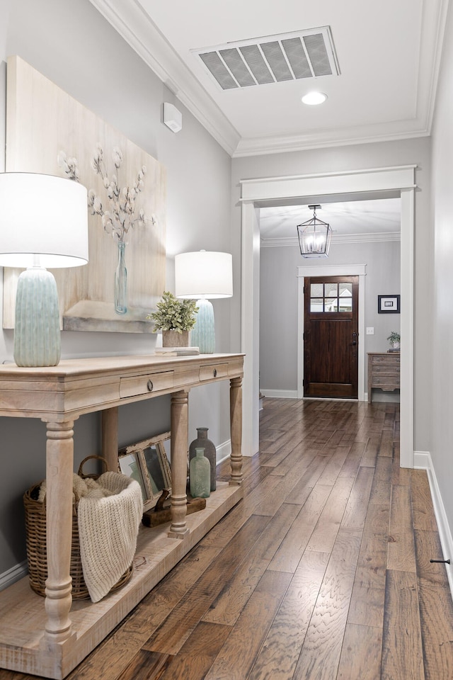 entrance foyer featuring crown molding and dark hardwood / wood-style floors