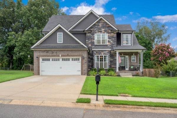 craftsman-style house with a garage and a front lawn