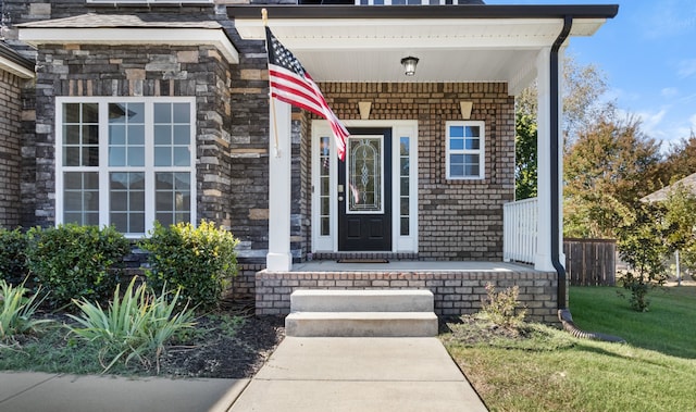 property entrance with a lawn