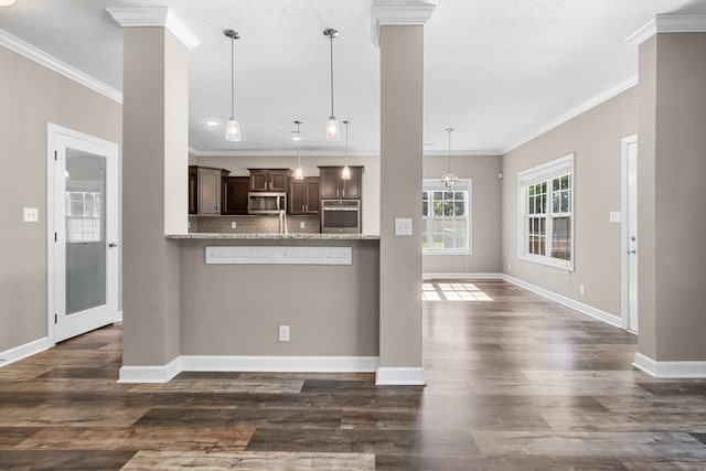 kitchen featuring kitchen peninsula, dark hardwood / wood-style floors, dark brown cabinetry, and stainless steel appliances