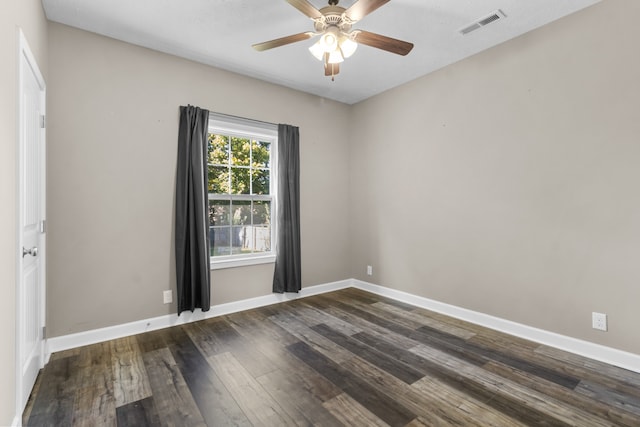 unfurnished room featuring dark wood-type flooring and ceiling fan