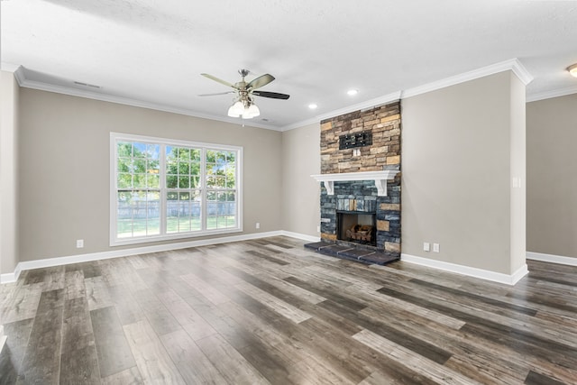 unfurnished living room with hardwood / wood-style floors, ceiling fan, a textured ceiling, a stone fireplace, and crown molding