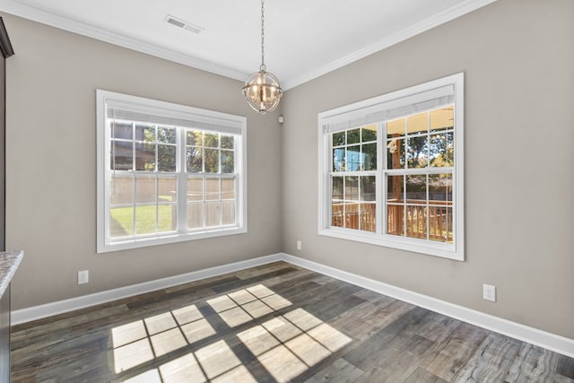 unfurnished dining area with dark wood-type flooring, a notable chandelier, and ornamental molding