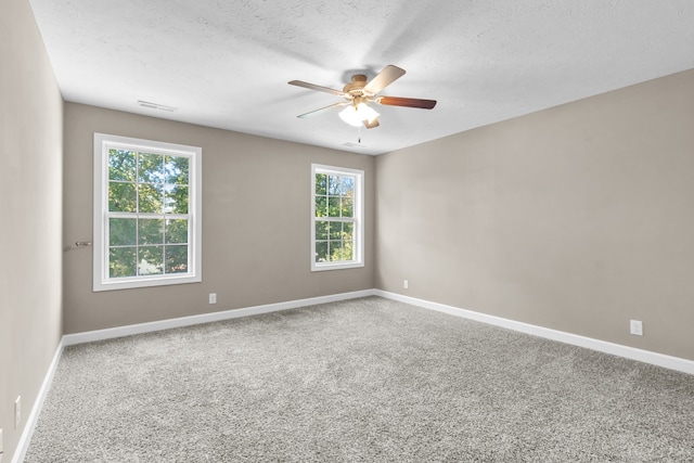 carpeted empty room with a textured ceiling and ceiling fan