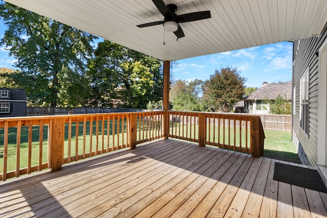 wooden deck with a yard and ceiling fan