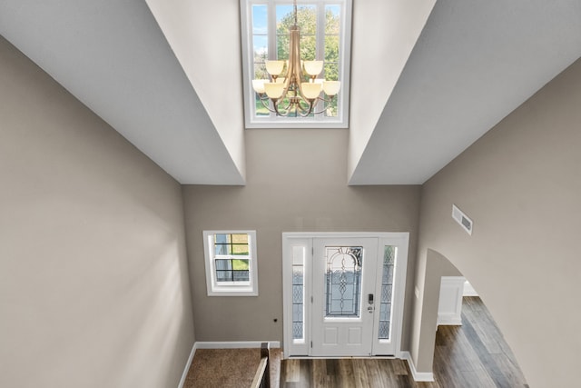 entrance foyer with dark wood-type flooring and a notable chandelier