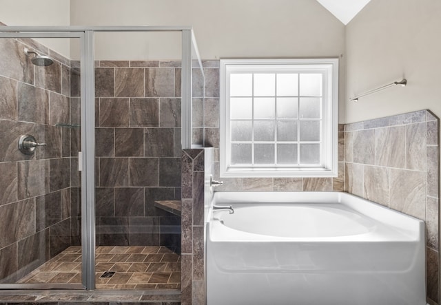 bathroom with lofted ceiling and separate shower and tub