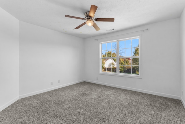 empty room featuring carpet flooring and ceiling fan