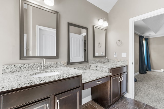 bathroom with vanity and vaulted ceiling