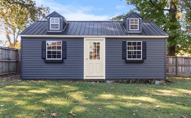 view of outbuilding with a yard