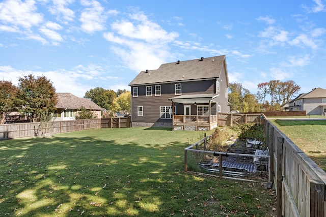 back of house with a yard and a wooden deck