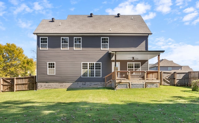 rear view of property with a yard and ceiling fan