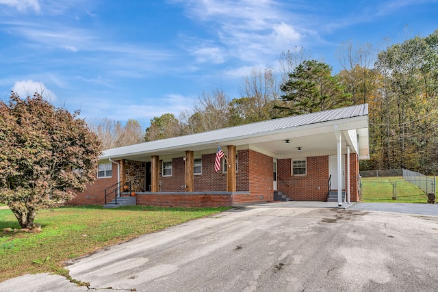 ranch-style home with a front yard and a carport