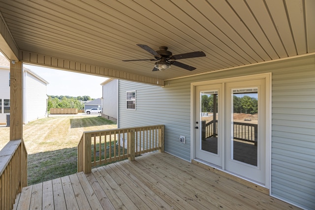 wooden terrace featuring a yard and ceiling fan