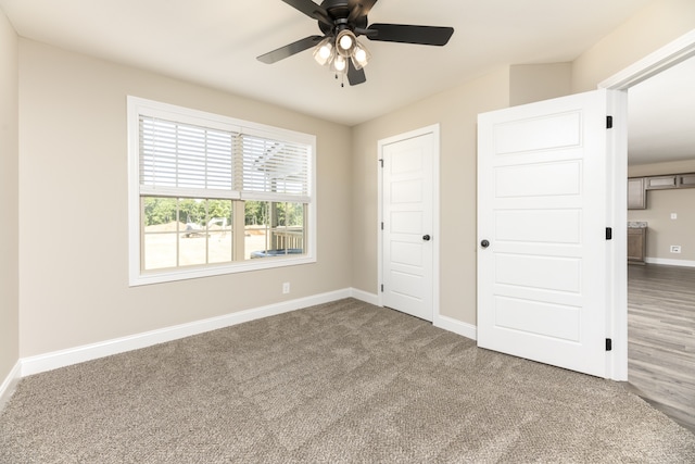 unfurnished bedroom featuring vaulted ceiling, carpet flooring, and ceiling fan