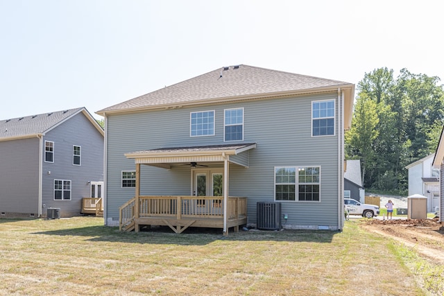 back of property with a deck, cooling unit, a lawn, and ceiling fan