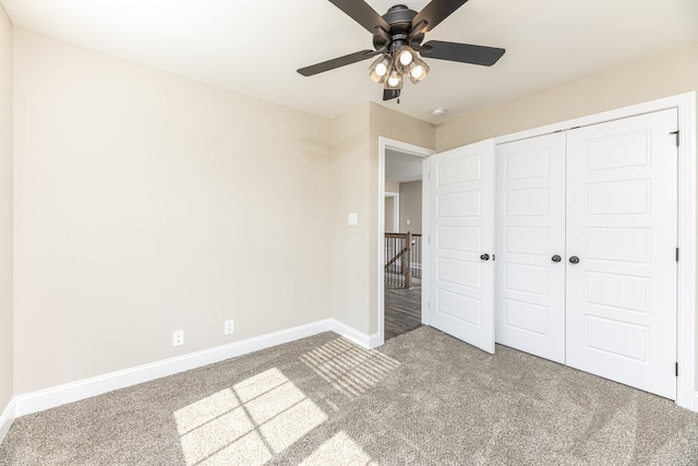 unfurnished bedroom featuring a closet, carpet flooring, and ceiling fan