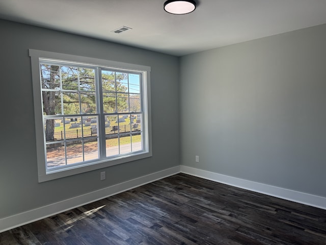 empty room featuring dark wood-type flooring