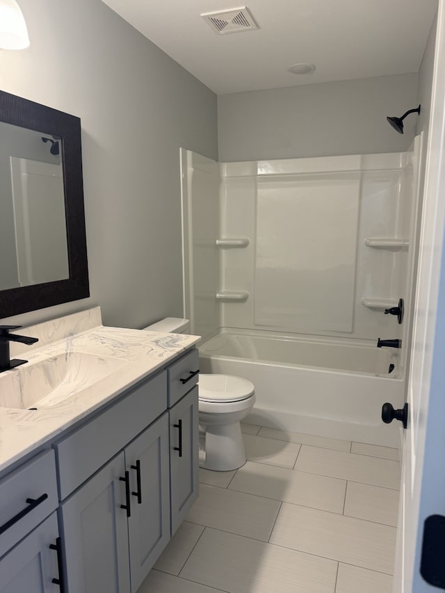 full bathroom with vanity, toilet, tile patterned flooring, and tub / shower combination