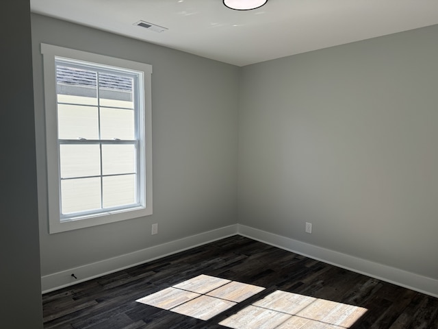 unfurnished room featuring dark hardwood / wood-style flooring